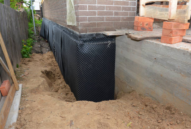 Happy homeowners after waterproofing job in Warners